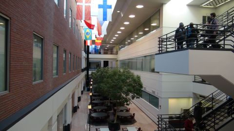 1993 Ford Taurus - An indoor atrium with international flags, seating areas, and people on multiple levels.