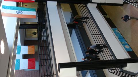 1993 Ford Taurus - Interior view of a building atrium national flags and people on walkways.