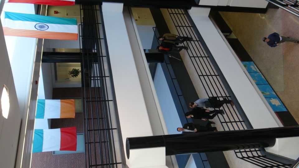 Interior of a building with flags of India, Ireland, and Italy hanging