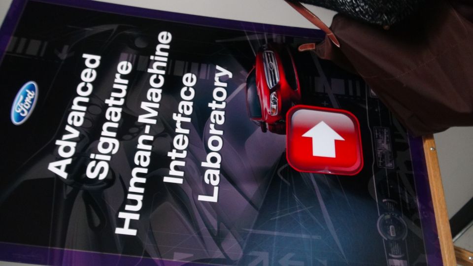 Ford logo and text reading 'Advanced Signature Human-Machine Interface Laboratory' on a sign