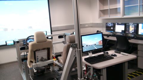 1993 Ford Taurus - A driving simulator setup is shown with a large screen and computer monitors.