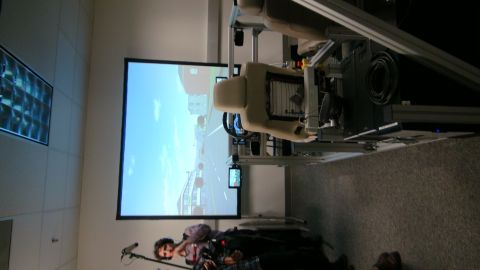 1993 Ford Taurus - A person operates a driving simulator that projects a road scene onto a large screen.