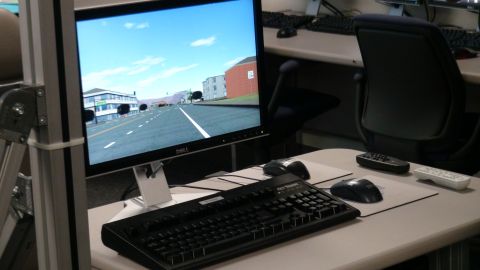 1993 Ford Taurus - A computer monitor displays a driving simulator scene, not a 1993 Ford Taurus.