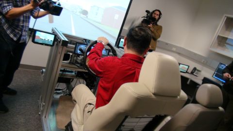 1993 Ford Taurus - A person operates a driving simulator while cameras record the session.