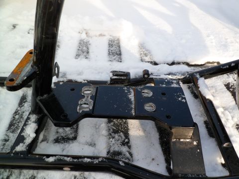 1973 Harley-Davidson Ultra - The photo shows a close-up view of vehicle frame components, partially covered in snow.