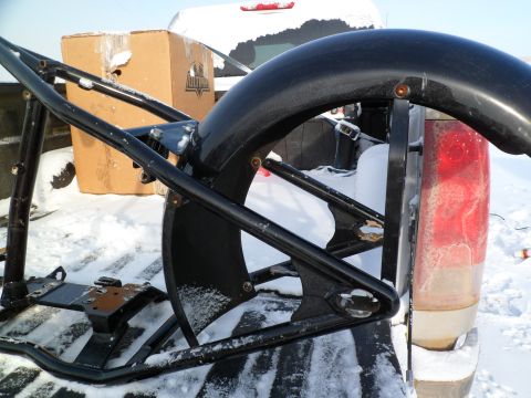 1973 Harley-Davidson Ultra - A motorcycle frame and fender are loaded into a truck bed covered in snow.