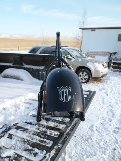 1973 Harley-Davidson Ultra - A black motorcycle fairing a CFL logo is loaded into a truck bed, with a tan SUV visible in the background on a snowy day.