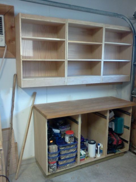 1996 Ford Bronco - Garage storage unit with shelves and a workbench holding various items.