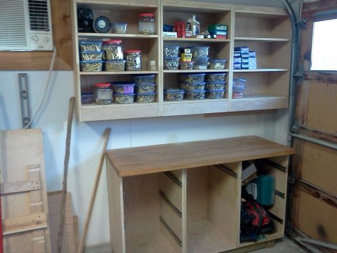 1996 Ford Bronco - Garage interior with a workbench and shelves containing various items and supplies.