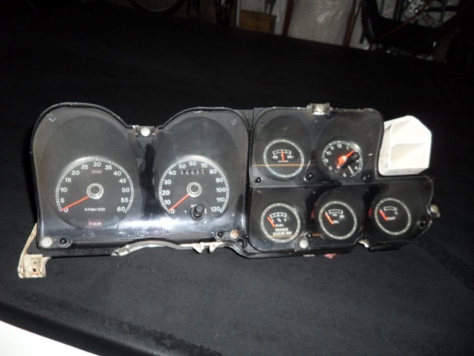 Car dashboard instrument cluster with speedometer, tachometer, fuel gauge, and oil pressure gauge