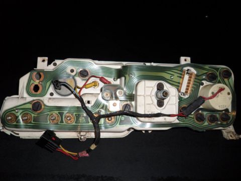 1973 Ford Ranchero - The intricate wiring and circuit board of a vehicle's instrument cluster are visible against a dark background.
