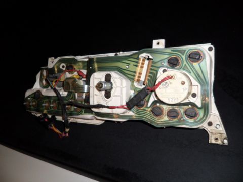 1973 Ford Ranchero - The back of a vehicle's instrument cluster circuit board shows intricate wiring and electronic components.