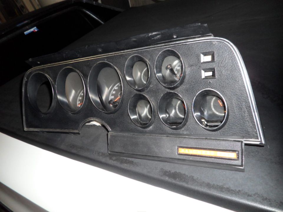 1973 Ford Ranchero dashboard instrument cluster with multiple gauges and switches