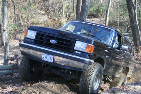 1987 Ford Bronco - This 1987 Ford Bronco is navigating a muddy, wooded path.