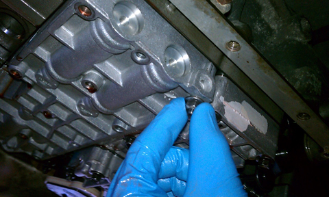 1993 Ford Bronco - Pull the old valve body out, and slide the new one in. Sorry I forget the torque specs, but I usually put them in finger tight, then start…