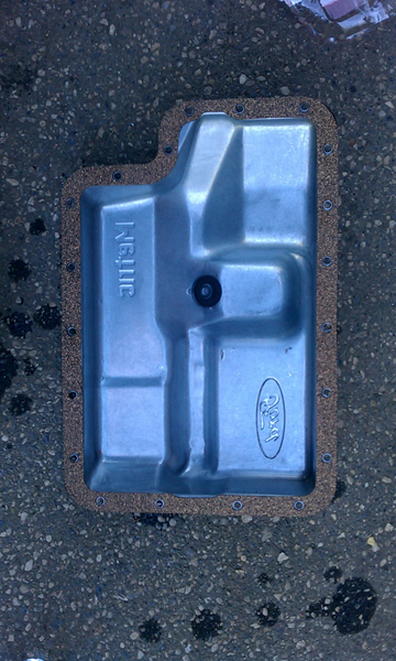 1993 Ford Bronco - I put the gasket on the pan and get it all lined up with a couple of bolts, then slide it back on. Again, putting all the bolts in finger t…