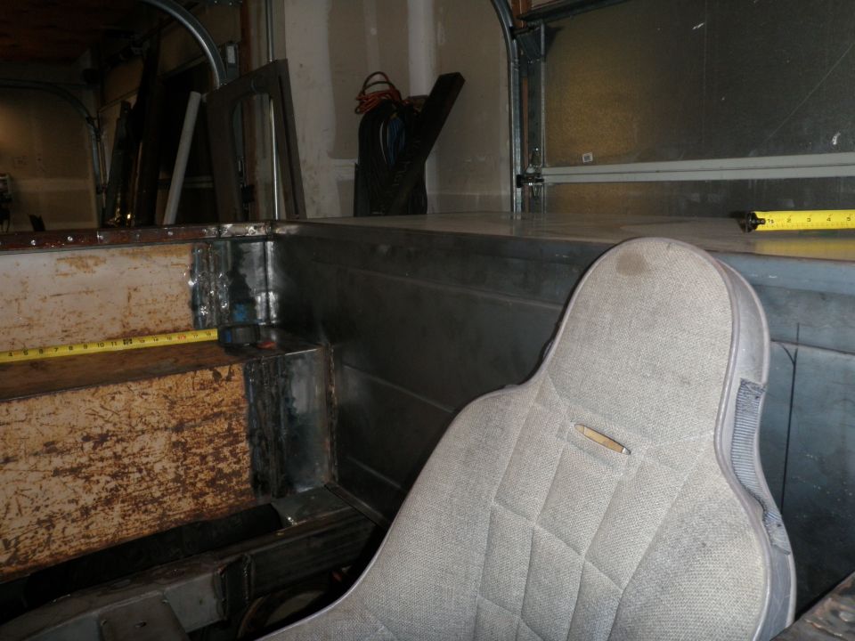 Bucket seat interior with metal paneling and a yellow measuring tape