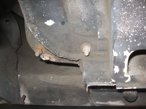 1994 Ford Bronco - Close-up view of the vehicle's undercarriage, showing signs of wear and corrosion.