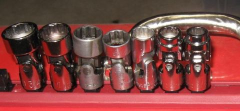 2000 Ford Crown Victoria - A set of chrome universal joint sockets is neatly organized in a red toolbox.