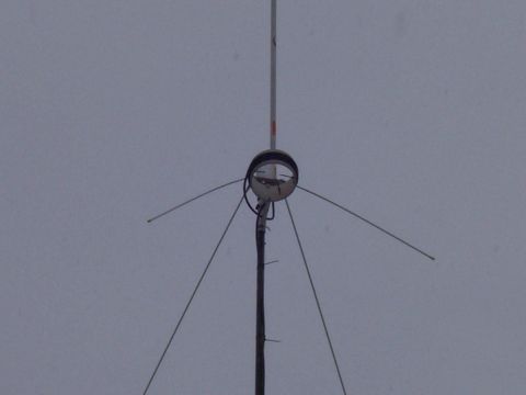 1978 Ford F-150 - An antenna structure is visible against an overcast sky, with a circular reflector at its center.
