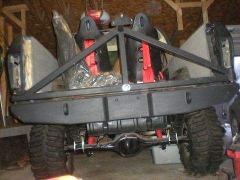 1978 Ford Bronco - Custom rear bumper and roll cage installed on an off-road vehicle, showing racing seats and suspension components.