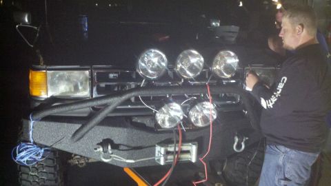 1991 Ford Bronco - The front of a 1991 Ford Bronco is shown, an aftermarket bumper, winch, and multiple auxiliary lights.