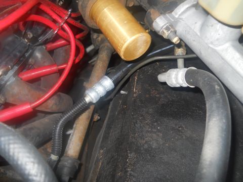 1976 Ford Bronco - Close-up view of engine bay components, including hoses and wiring.