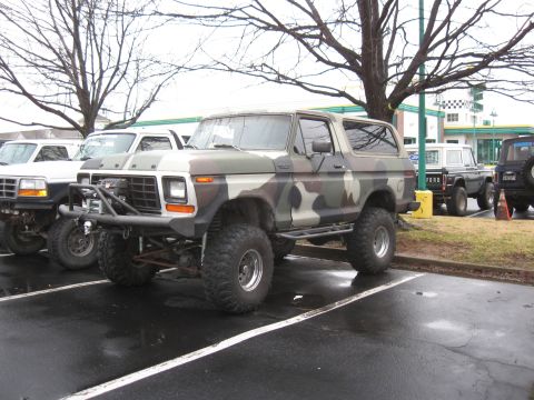 1994 Ford Bronco - This lifted Ford Bronco features a camouflage paint job and aftermarket off-road modifications.