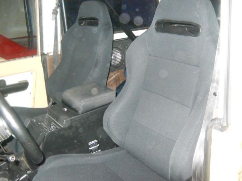 1976 Ford Bronco - The interior features aftermarket racing seats and a custom center console, obscuring specific year identification.