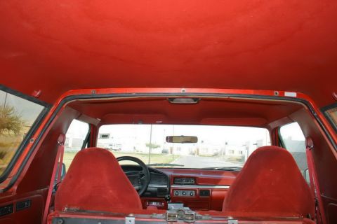 1995 Ford Bronco - Interior view of a 1995 Ford Bronco, showing the red seats and dashboard.