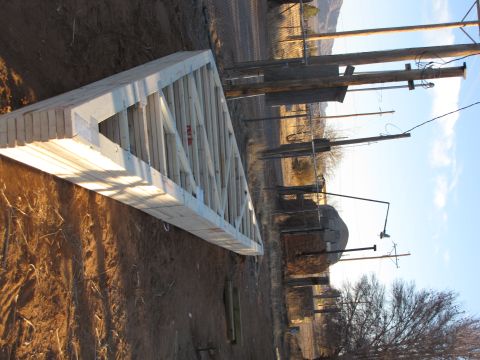 1995 Ford Bronco - A wooden roof truss is visible on the ground near utility poles under a clear sky.
