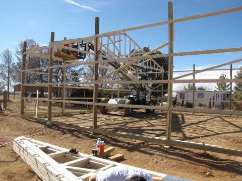 1995 Ford Bronco - Construction scene with a telehandler and building materials under a clear blue sky.