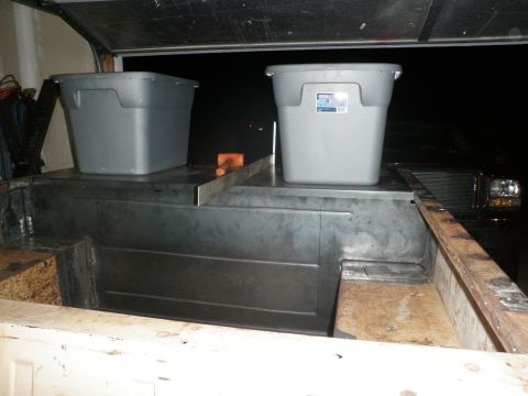 1961 International Scout 800 - Custom metal bed liner and storage bins are visible inside a garage, with a vehicle partially seen in the background.