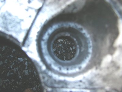 1997 Ford Taurus - This image shows a close-up of a dirty engine component with debris visible within its opening.