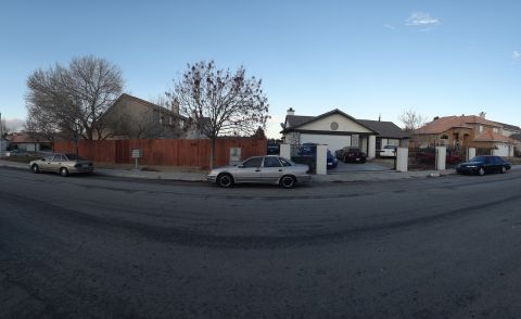 1993 Ford Taurus - A silver 1993 Ford Taurus sedan is parked on the street in front of a residential house.
