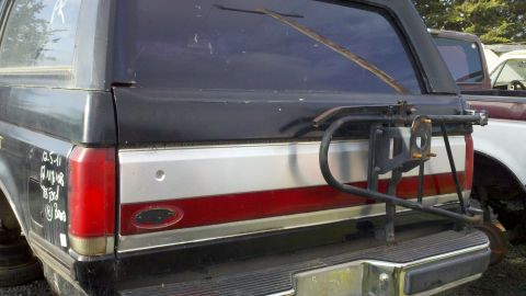 1978 Ford Bronco - This Bronco's rear end features a swing-away spare tire carrier and a distinctive red and silver stripe detail.