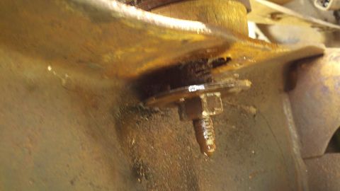 1978 Ford Bronco - A close-up view of a corroded metal component, likely part of a vehicle's undercarriage.