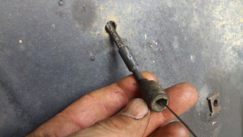 1978 Ford Bronco - A hand holds a cable release mechanism against a textured surface, with the Supermotors logo in the corner.