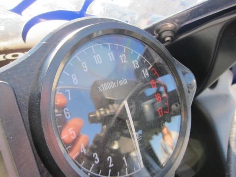1999 Mercury Grand Marquis - Close-up of a motorcycle's tachometer, with the needle indicating a low RPM and the redline marked from 15 to 17.