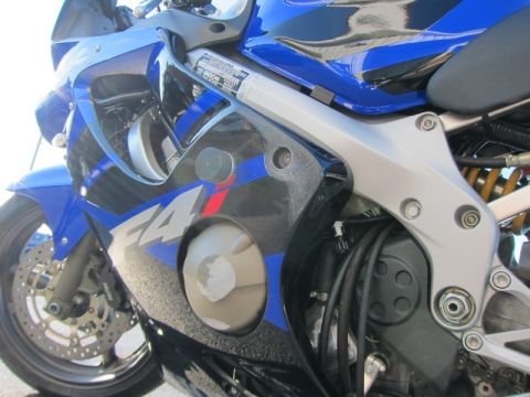 1999 Mercury Grand Marquis - Close-up view of a blue sport motorcycle's side fairing and engine components.