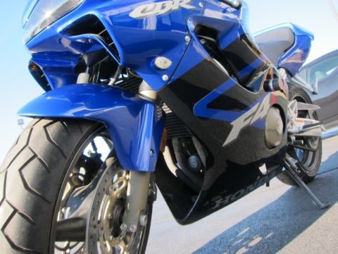 1999 Mercury Grand Marquis - Front view of a blue and black Honda CBR motorcycle, with 'CBR' and 'F4i' visible on the fairing.