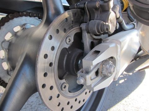 1999 Mercury Grand Marquis - This photo shows the rear brake assembly and chain of a motorcycle, not a 1999 Mercury Grand Marquis.