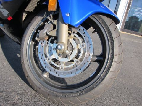 1999 Mercury Grand Marquis - Close-up of a blue motorcycle's front wheel, its dual disc brakes and Pirelli tire. The registry information appears to be incorrect.