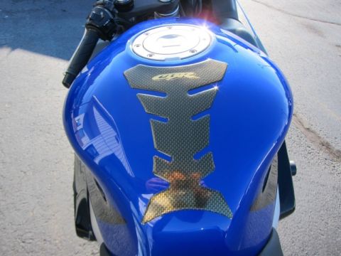 1999 Mercury Grand Marquis - Close-up of a blue motorcycle fuel tank with a carbon fiber grip pad and CBR branding.