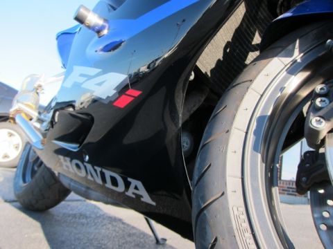1999 Mercury Grand Marquis - A motorcycle's side fairing and front tire are visible in this close-up shot.