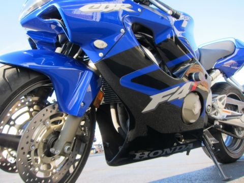 1999 Mercury Grand Marquis - Close-up of a blue and black Honda CBR F4i motorcycle, showing the front fairing and wheel.