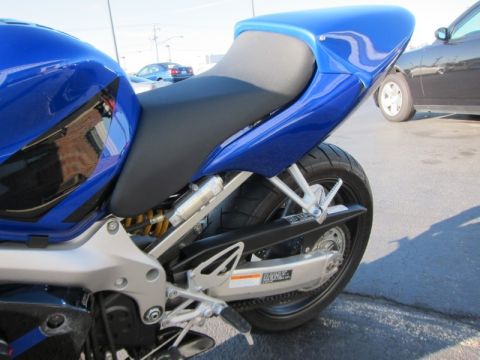 1999 Mercury Grand Marquis - Close-up view of the rear section of a blue motorcycle, showing the seat, swingarm, and tire.