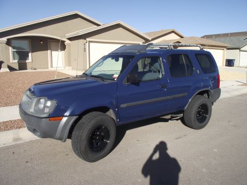 2004 Nissan Xterra - Side view with new Pro Comp wheels and center caps.