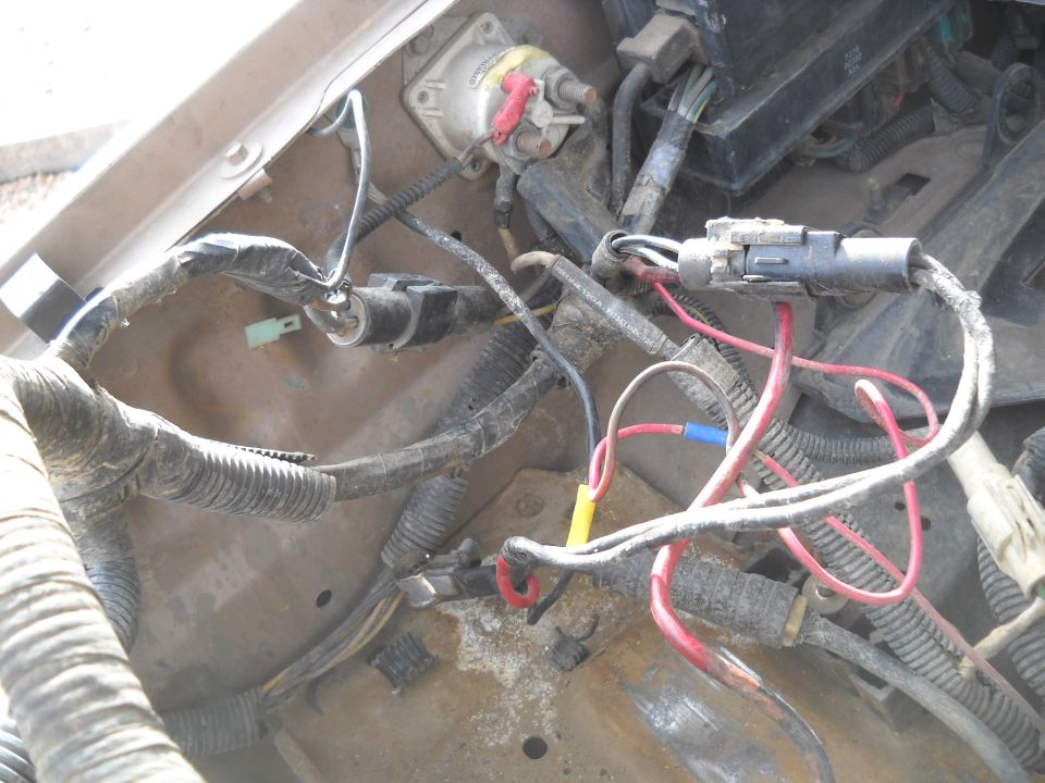 Engine wiring harness with red, yellow, and blue connectors, and a white solenoid