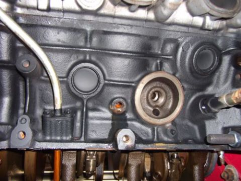 1991 Ford Taurus - Close-up of an engine block, focusing on the oil filter housing and associated components.
